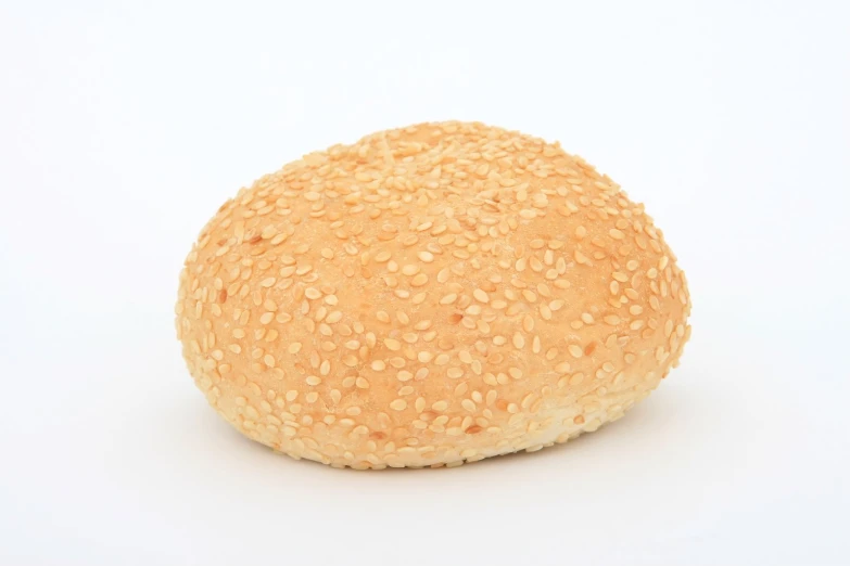 a sesame seed bread roll on a white background