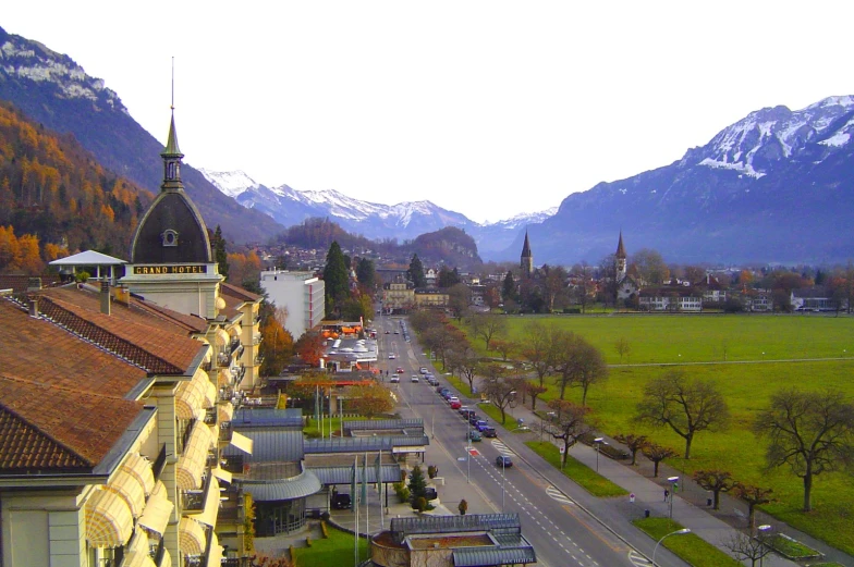 a small village with mountains in the distance