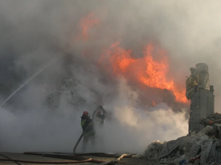 firefighters battle a large fire while putting out a huge blaze