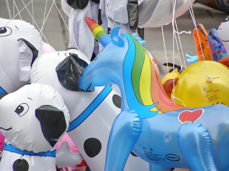 several inflated balloons have horses, dogs and other animals in the shape of balloons