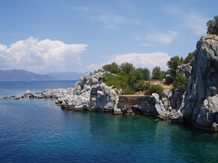 a rock formation is seen in the water