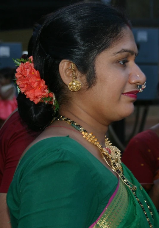 a woman with a jewelry and a flower in her hair