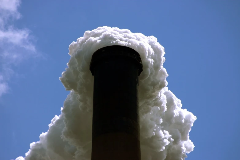 the steam is pouring from a factory chimney