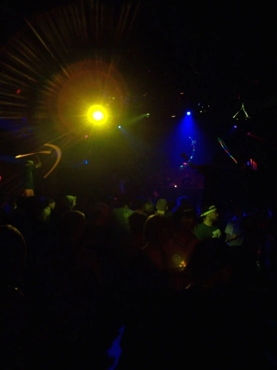 an empty dark club with brightly colored lights and people