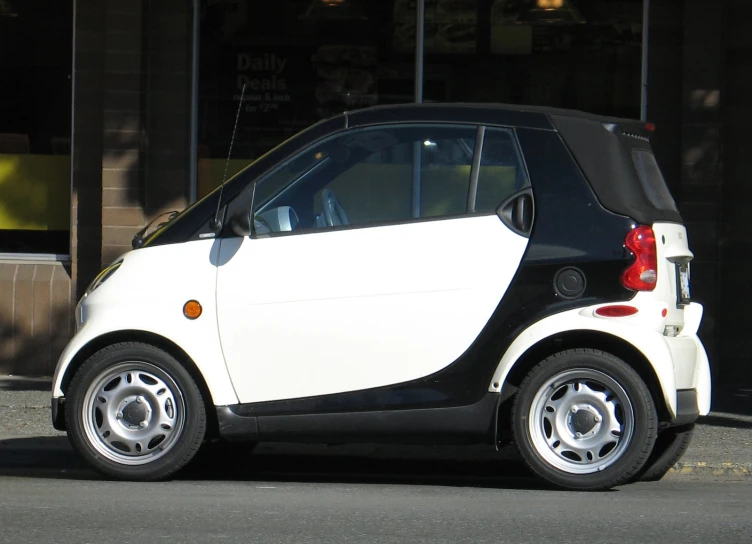 a small electric car parked in a parking lot