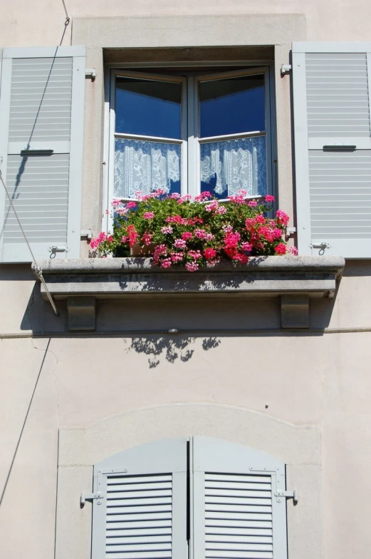 a window with white shutters and blue shutters