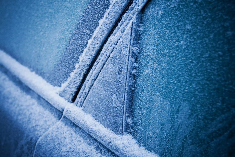 the snow is melting on the car windows