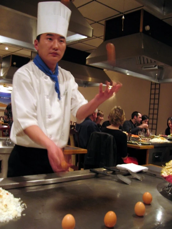 a chef throwing up some kind of dog