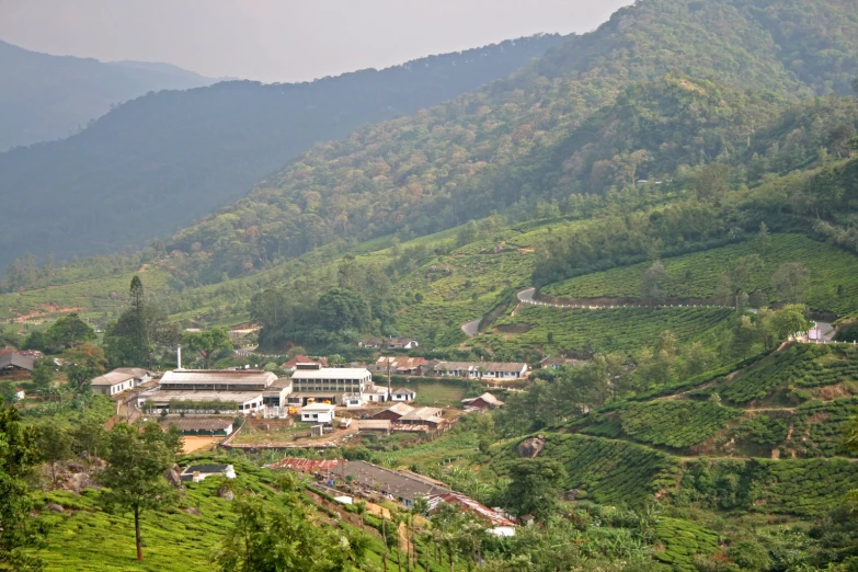 some mountains and buildings with hills in the background