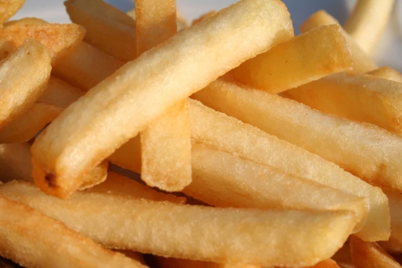an arrangement of french fries on a white plate