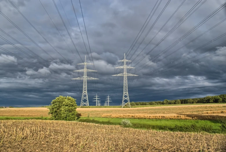 a field with many power lines in the background