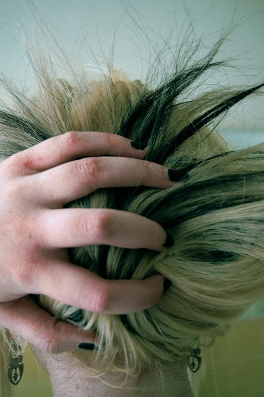 a woman is shown holding her hair back with one hand