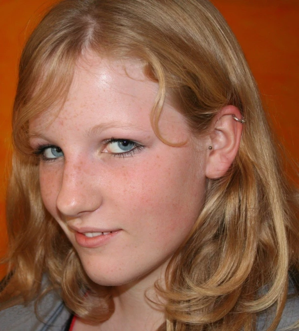 close up of a blonde female with blue eyes