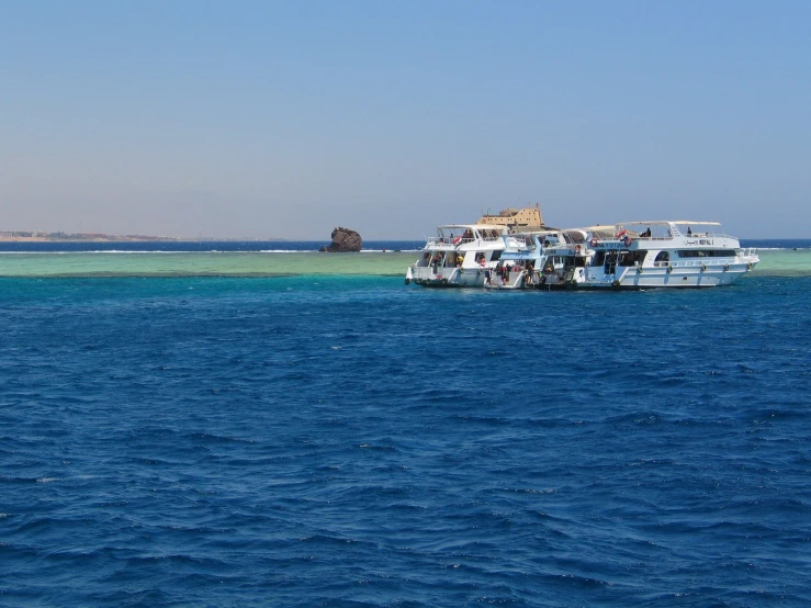 the boat is parked next to the beach