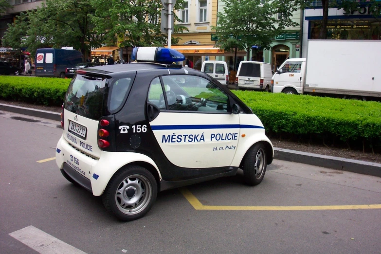 a small car on a city street with its back door open