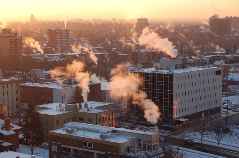 smoke billowing from buildings, and a city at sunset