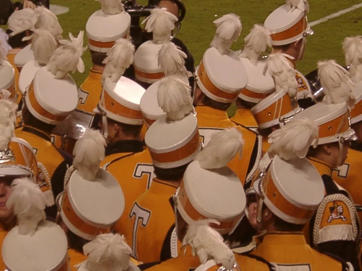 a group of dancers with drum heads on in uniform