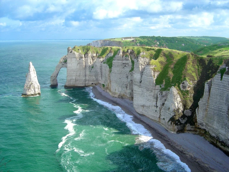 an aerial view of the cliffs near a beach