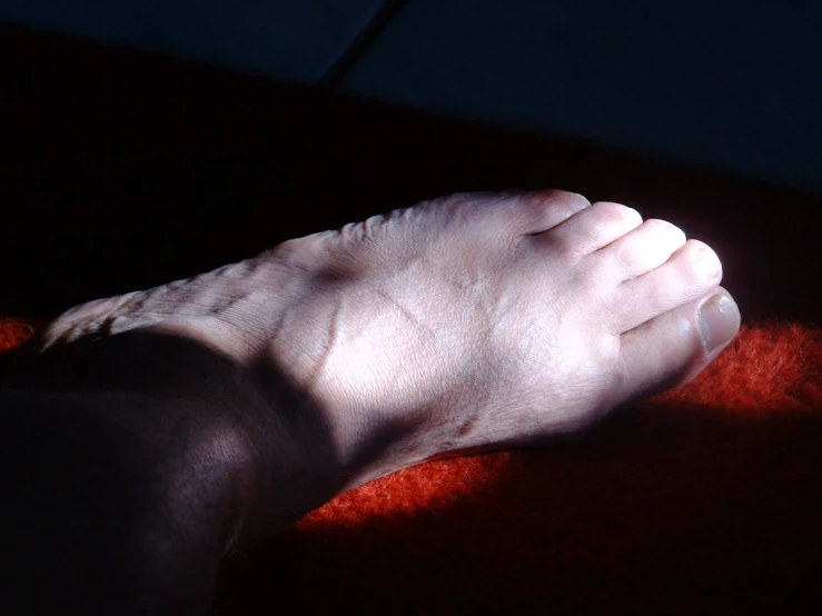 a barefoot person has their toes up and foot down