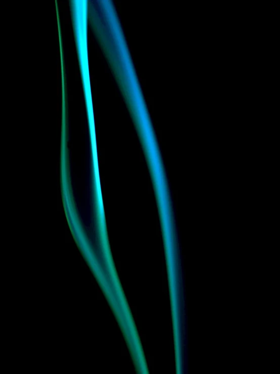 green and blue smoke against a black background