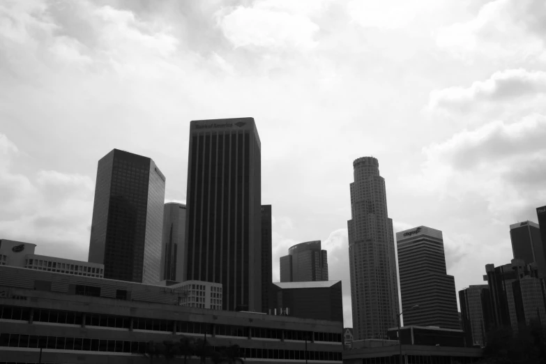 black and white po of buildings with cloudy sky