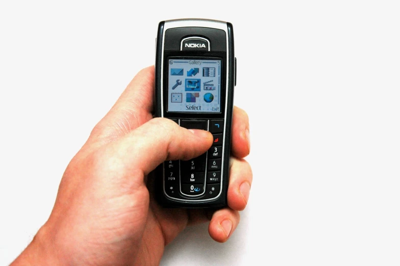 a person's hand is holding a flip phone with a on