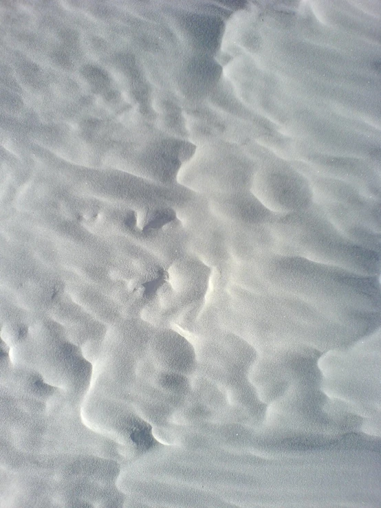 a snow covered ground with some white stuff