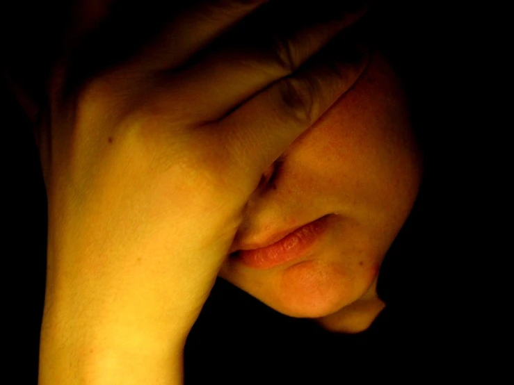 a person's face resting his head on their arm