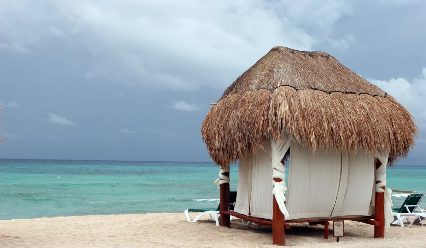 a chair and umbrella sit on the beach