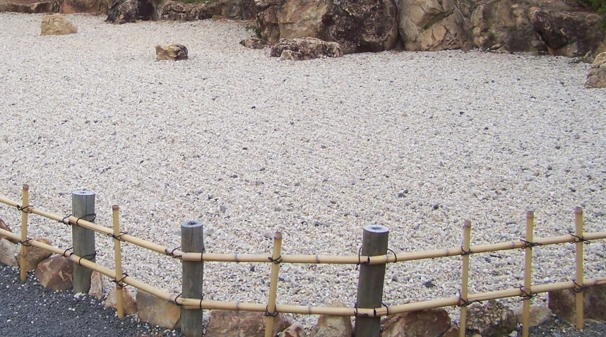 an animal park with a bridge and lots of rocks