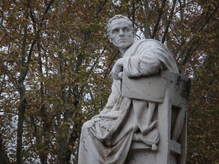 statue of a person with his hand on his lap looking upwards
