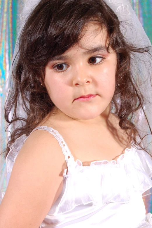 a girl is standing in a wedding dress