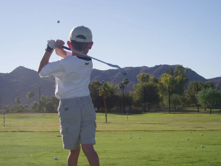 a young man is playing golf on the field