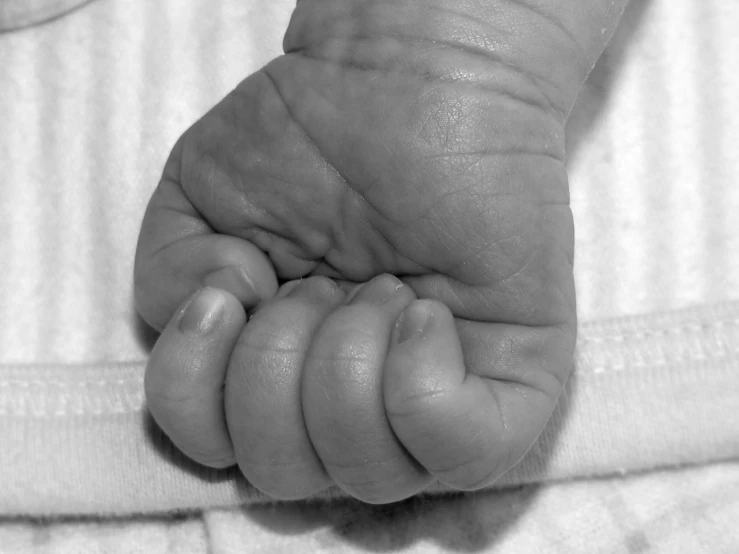 an image of a child showing off their tiny hand