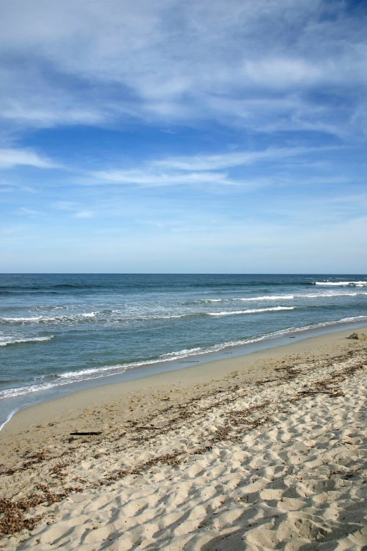 people with surfboards standing at the edge of the ocean