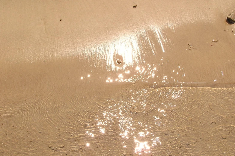 a beach scene with waves hitting the sand