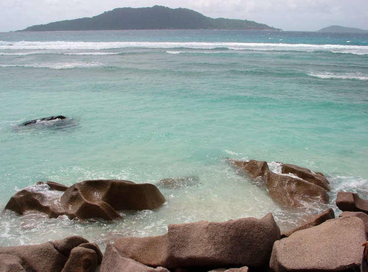 an ocean view looking at a body of water and rocks