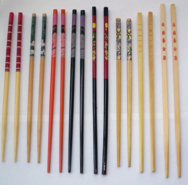 eight different colored chop sticks are sitting on a white surface