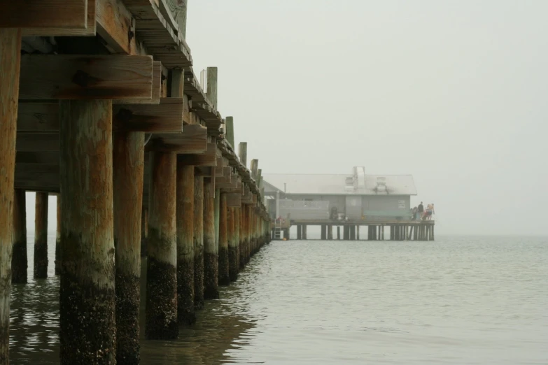 pier view with misty morning fog on the horizon