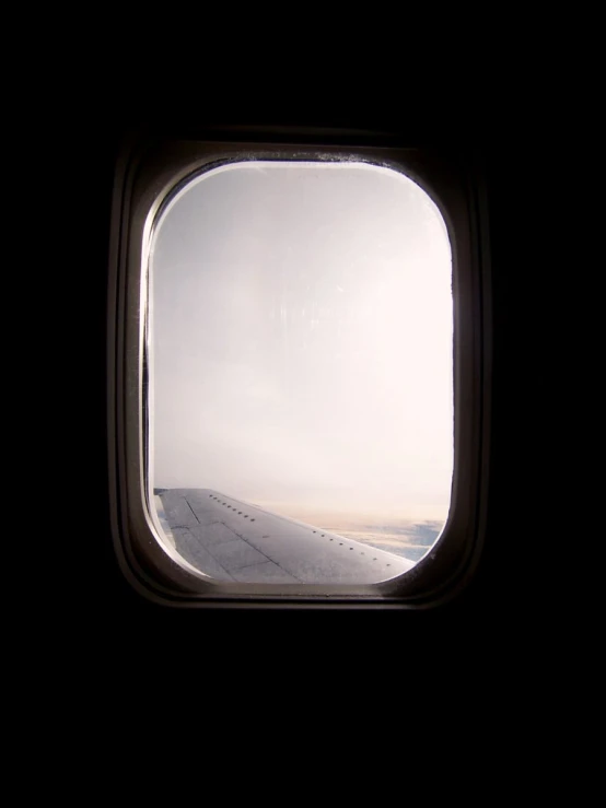 an airplane window with the light from inside