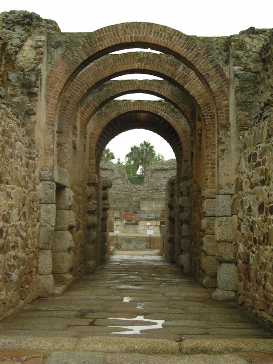 an archway with cobblestone floors and stone steps