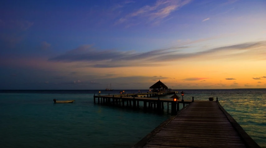 a house is on the dock while people walk along it