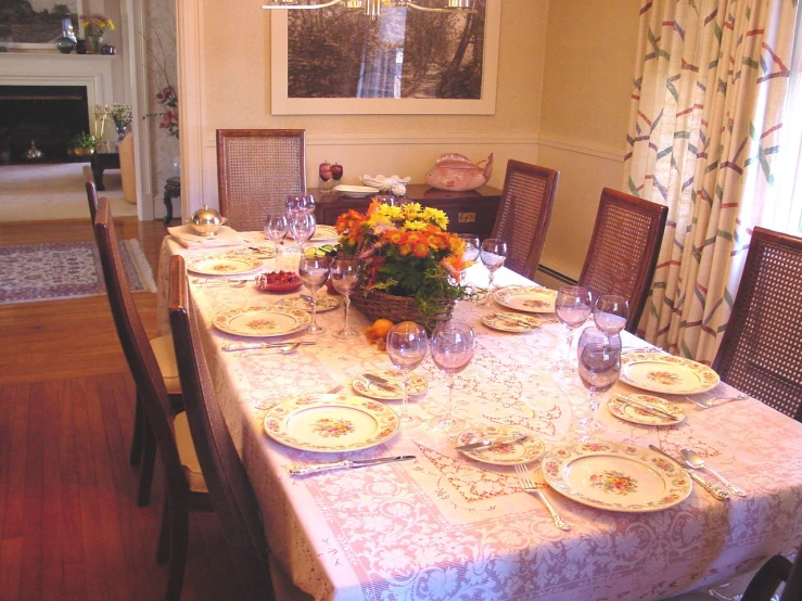 a dining room table with a dining room and chairs with flowers on the table