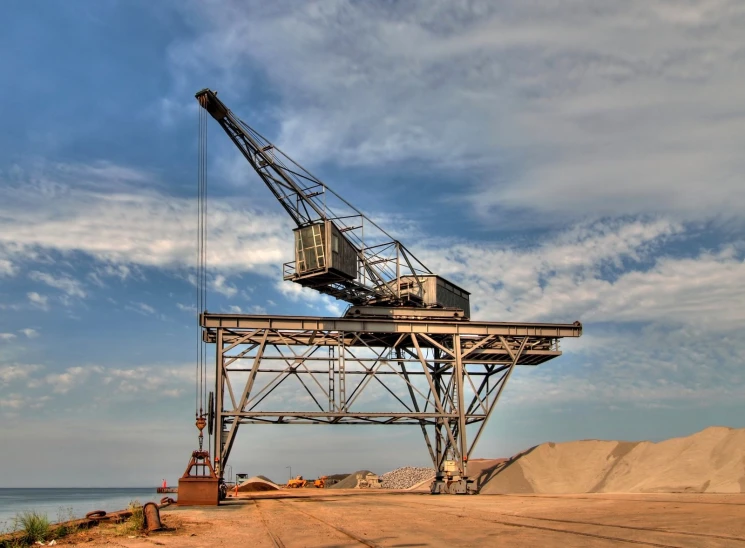 a large crane is on the side of the beach