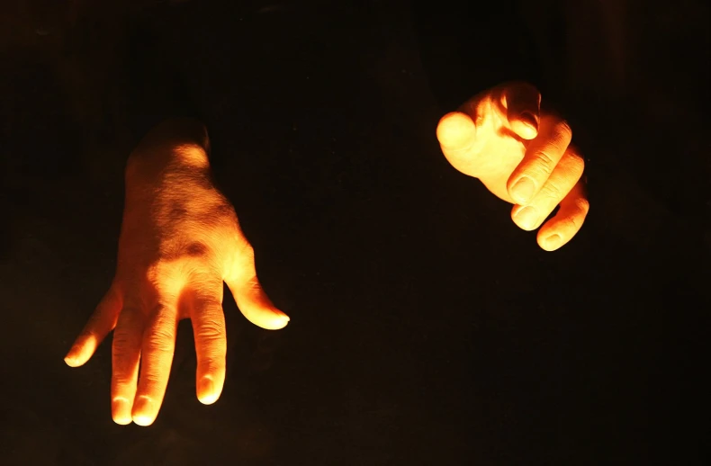 an individual has glowing hands and hand fingers