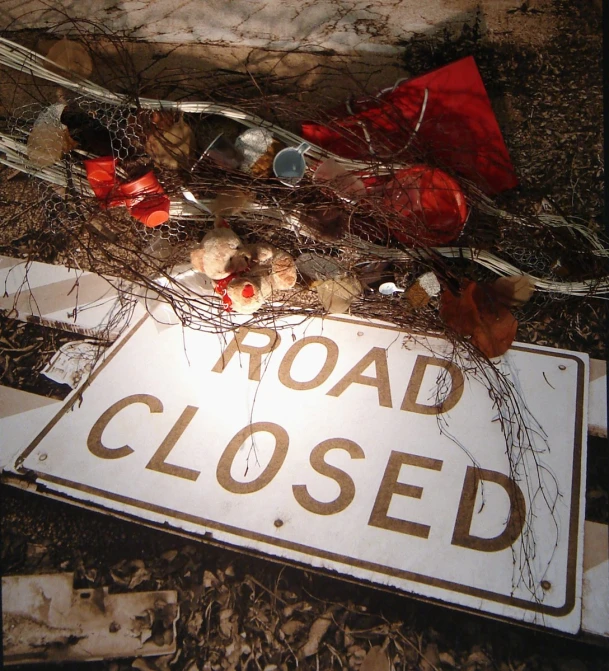 a close up of a road closed sign on a street