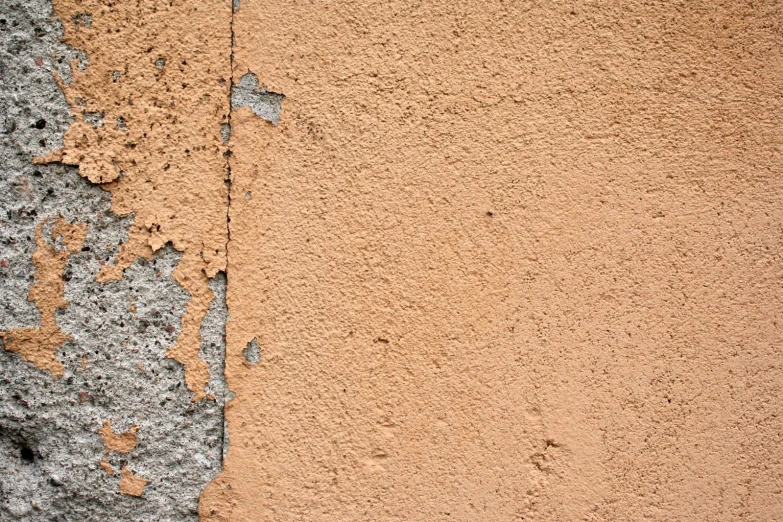 two layers of different colors on a cement wall