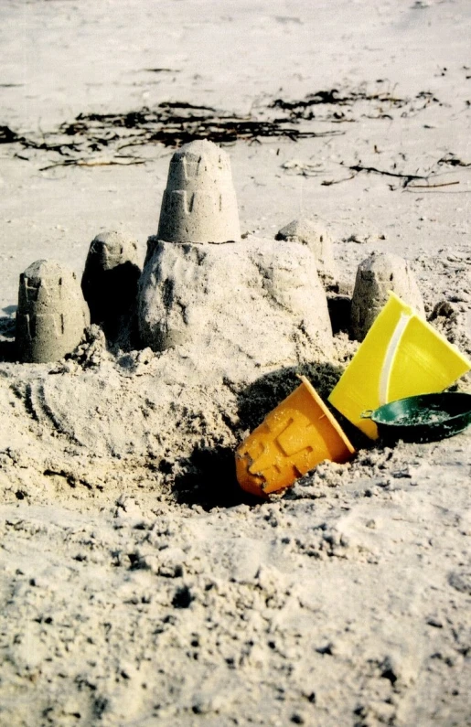 a sand castle in the beach with a cone on top