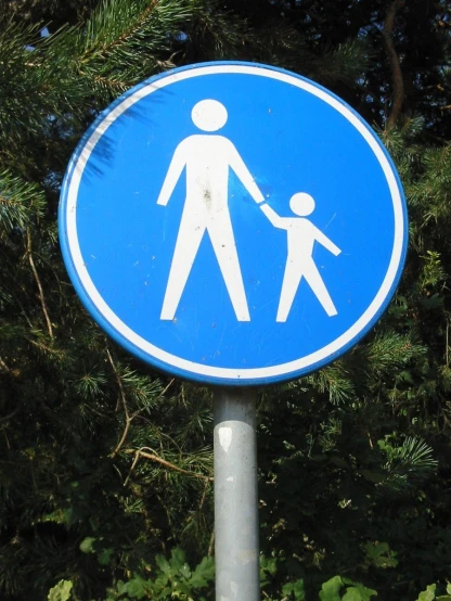 a sign that shows people holding hands and walking