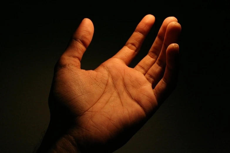 an orange hand on a black background